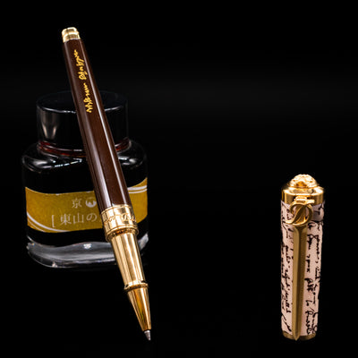 ST Dupont William Shakespeare Rollerball Pen - Preowned leaning on an ink bottle uncapped.
