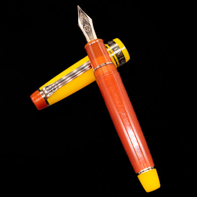 Sailor Professional Gear King of Pens Fountain Pen - Moonlight Over the Ocean laying on top of its cap in a crossed position showing full view of the entire uncapped pen.