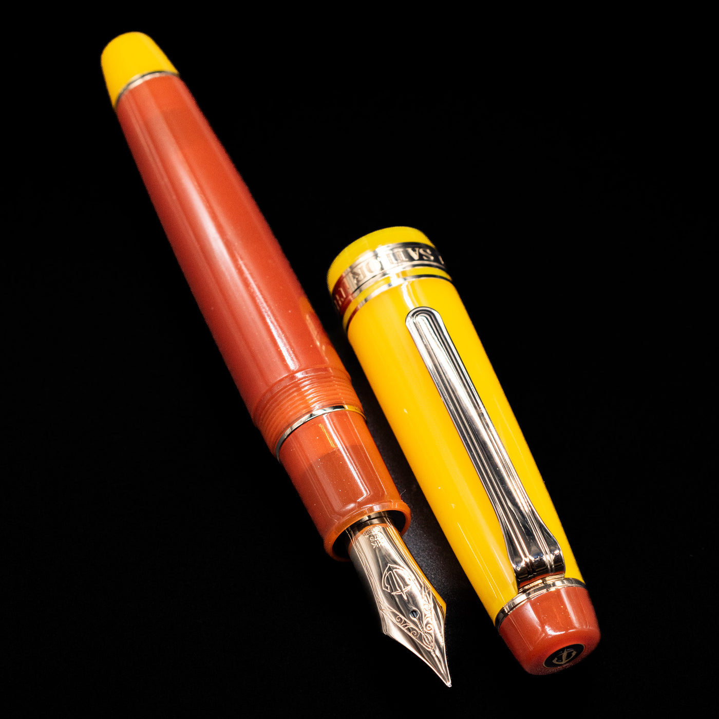  A full view of the Sailor Professional Gear King of Pens Fountain Pen - Moonlight Over the Ocean uncapped, with its cap laying next to the pen. 