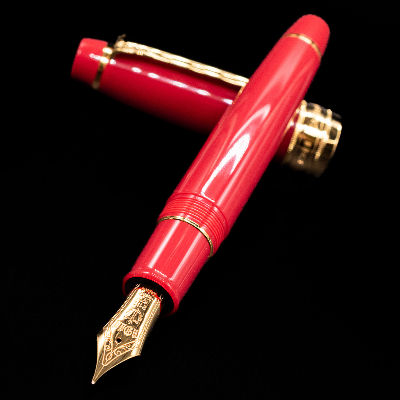 Sailor Professional Gear King of Pens Fountain Pen - Pillow Book Autumn Sky laying across its own cap, crossed, with a focus on the nib.