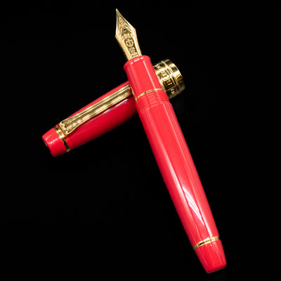 Sailor Professional Gear King of Pens Fountain Pen - Pillow Book Autumn Sky laying on top of its cap in a crossed position showing full view of the entire uncapped pen.