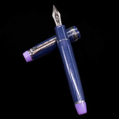Sailor Professional Gear King of Pens Fountain Pen - Storm over the Ocean laying on top of its cap in a crossed position showing full view of the entire uncapped pen.