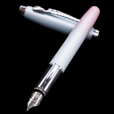Sheaffer 100 Fountain Pen - Expressions laying across its own cap, crossed, with a focus on the nib.