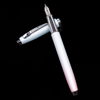 Sheaffer 100 Fountain Pen - Expressions laying on top of its cap in a crossed position showing full view of the entire uncapped pen.