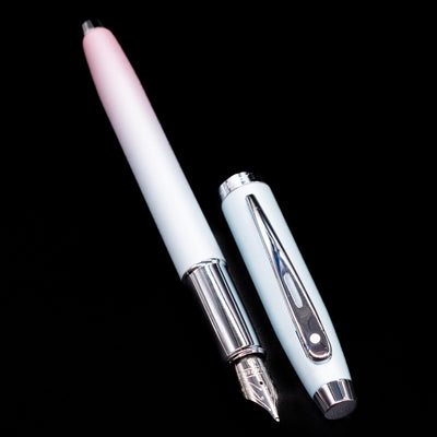 A full view of the Sheaffer 100 Fountain Pen - Expressions uncapped, with its cap laying next to the pen. 
