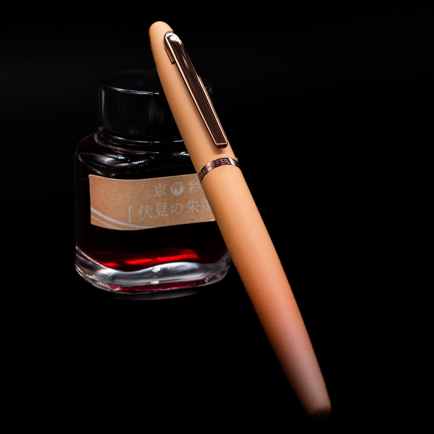 Sheaffer VFM Fountain Pen - Coffee (Special Edition) capped, leaning against an ink bottle. 