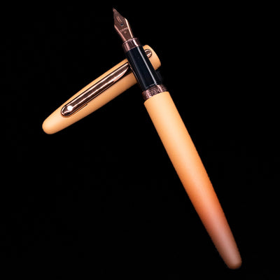 Sheaffer VFM Fountain Pen - Coffee (Special Edition) laying on top of its cap in a crossed position showing full view of the entire uncapped pen.