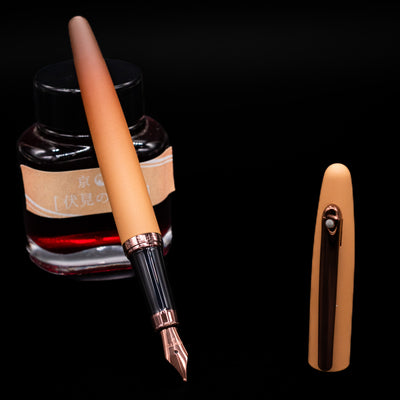 Sheaffer VFM Fountain Pen - Coffee (Special Edition) leaning on an ink bottle uncapped showcasing the detailing on the nib.