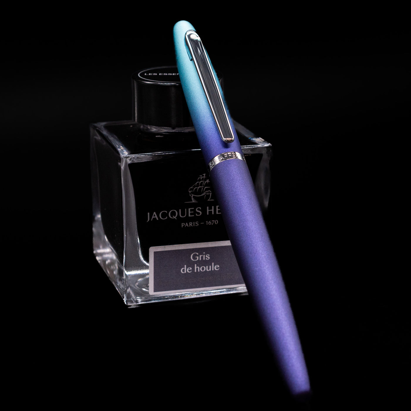 Sheaffer VFM Fountain Pen - Expressions capped, leaning against an ink bottle. 