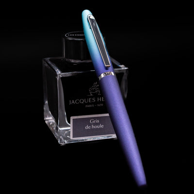 Sheaffer VFM Fountain Pen - Expressions capped, leaning against an ink bottle. 