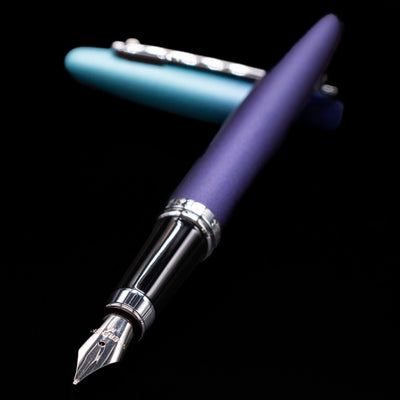 Sheaffer VFM Fountain Pen - Expressions laying across its own cap, crossed, with a focus on the nib.