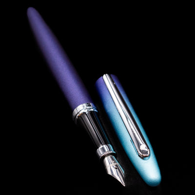 A full view of the Sheaffer VFM Fountain Pen - Expressions uncapped, with its cap laying next to the pen. 