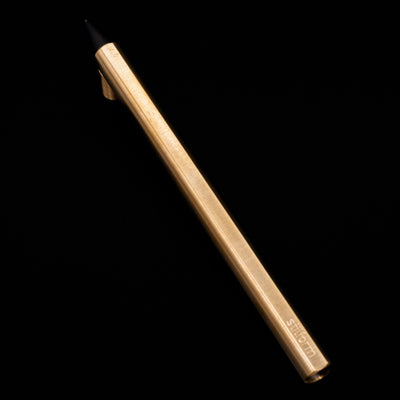 Full view of the Stilform FLOW Rollerball Pen – Brass Radial Brushed propped up on its cap.