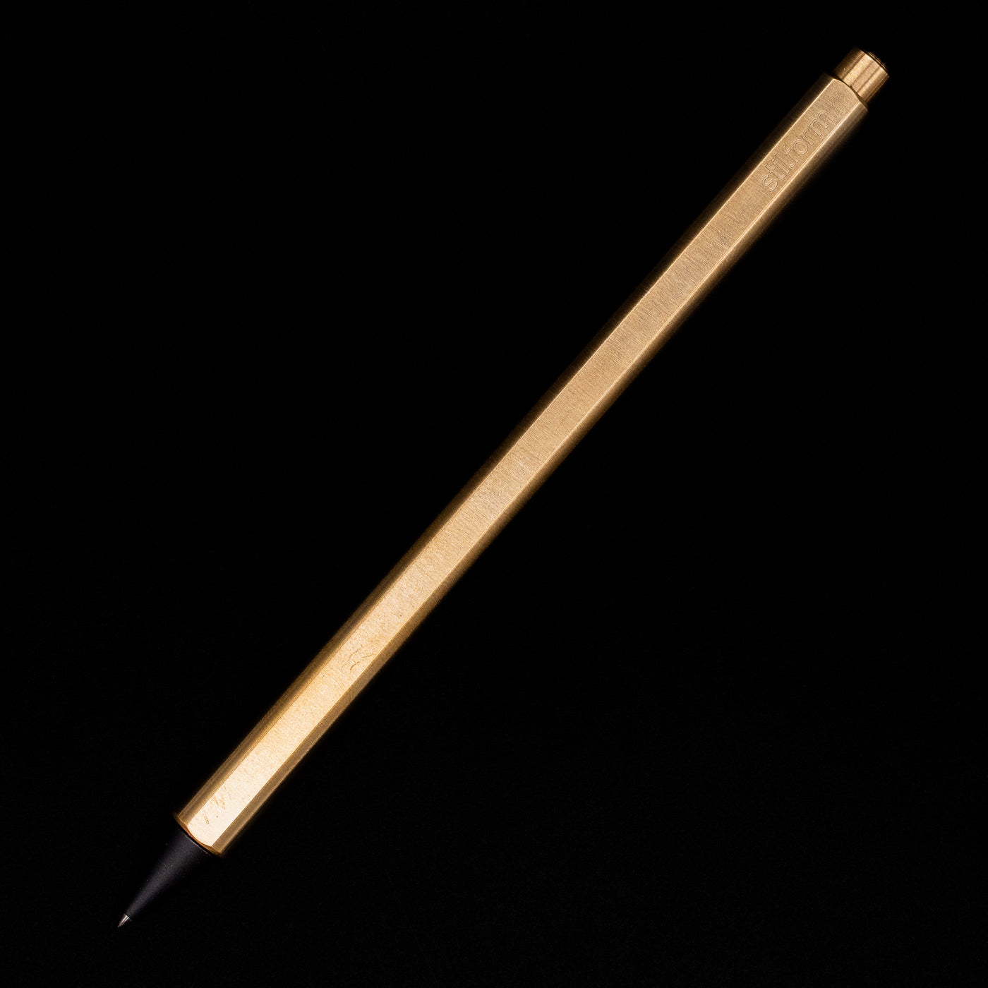 An overhead view of the Stilform FLOW Rollerball Pen – Brass Radial Brushed posted.