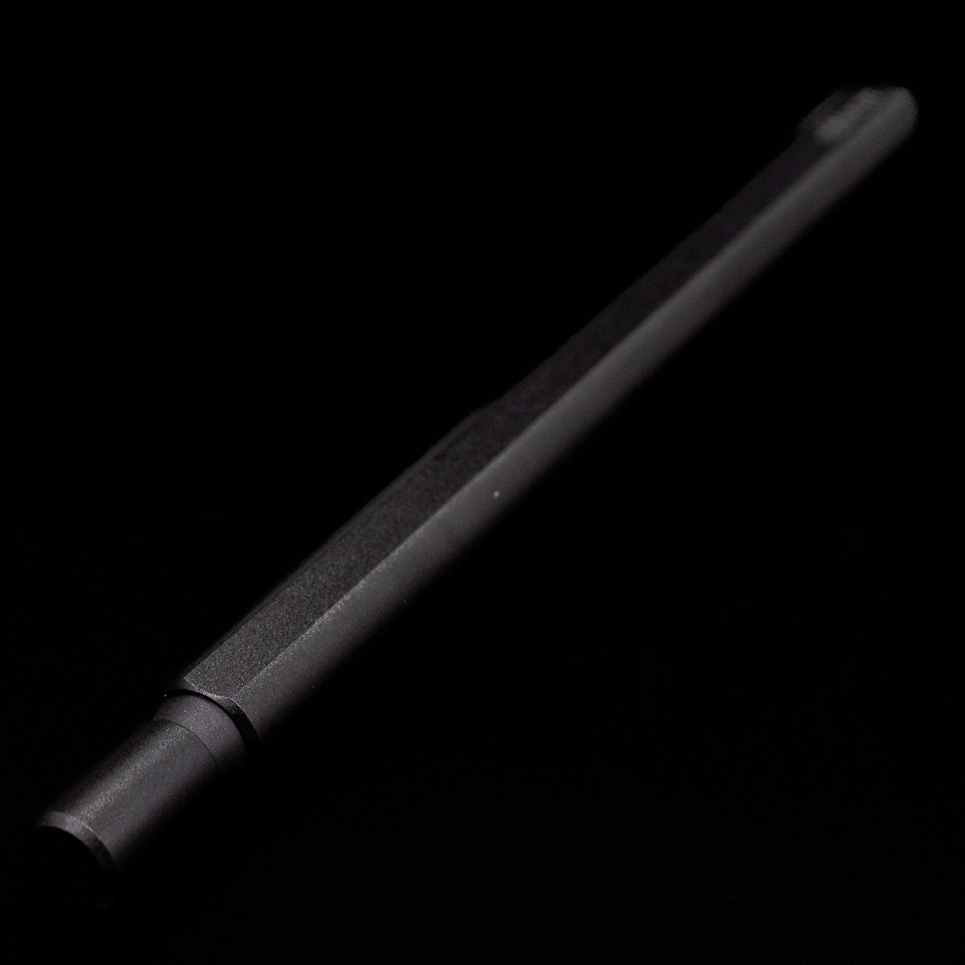 Full view of the Stilform FLOW Rollerball Pen – Warp Black Aluminum at an angle, capped, but activated.