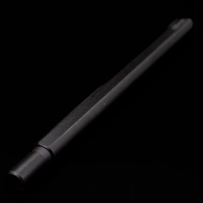 Full view of the Stilform FLOW Rollerball Pen – Warp Black Aluminum at an angle, capped, but activated.