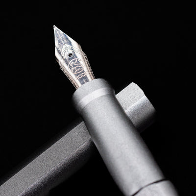 A macro shot of the nib with its intricate detailing and logo engraving for the Stilform INK Fountain Pen – Comet Grey Aluminum.