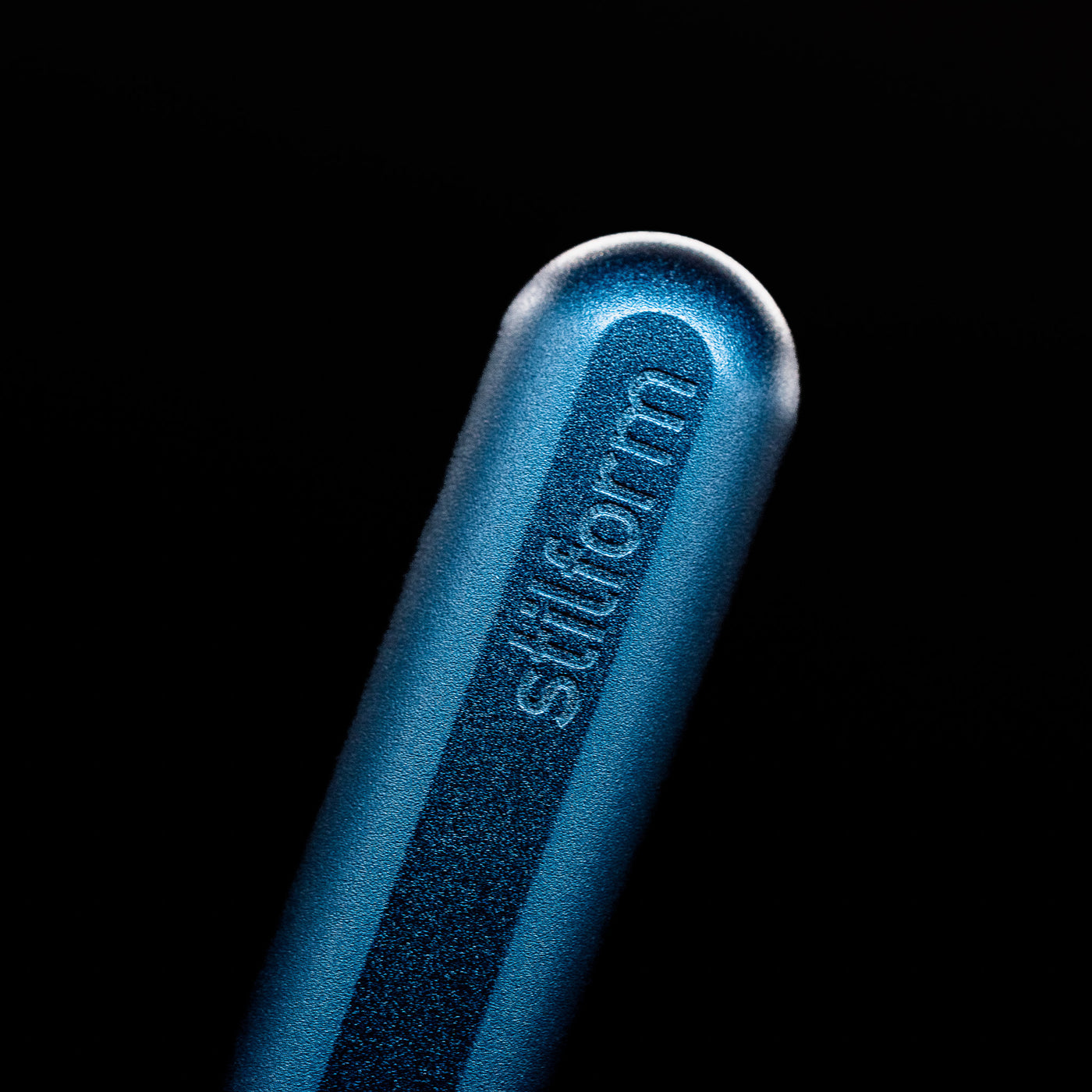A macro shot of the logo on the bottom of the body of the Stilform INK Fountain Pen – Night Sky Aluminum.