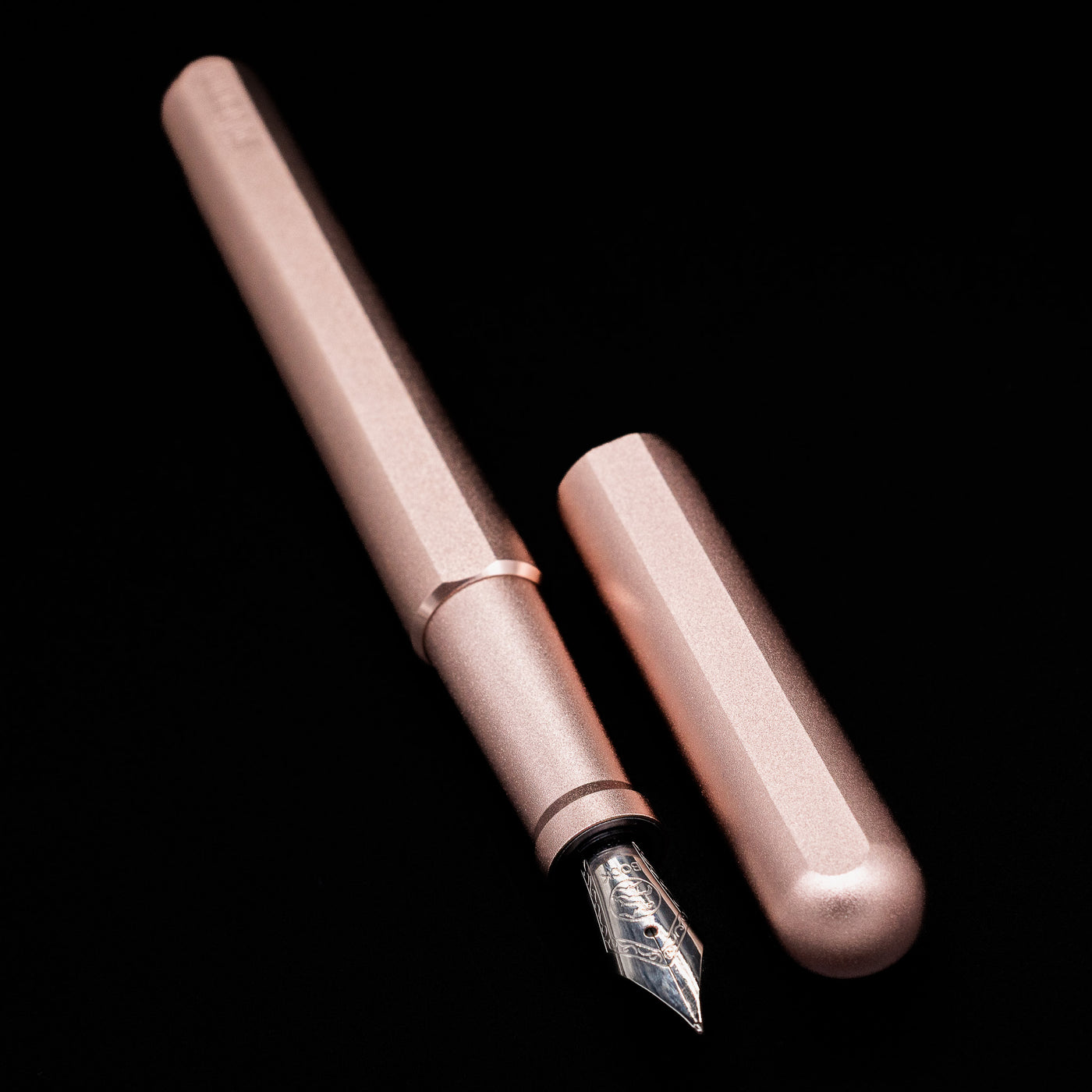 A full view of the Stilform INK Fountain Pen – Rose Moon Aluminum uncapped, with its cap laying next to the pen. 