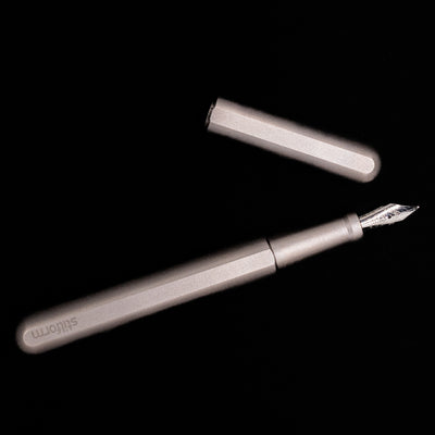 An overhead view of the Stilform INK Fountain Pen – Titanium Matte uncapped.