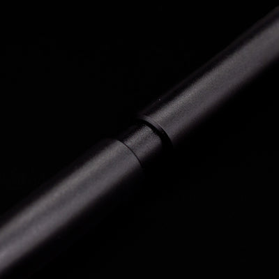 A macro shot of the part that activates the Stilform PEN Ballpoint Pen – Warp Black Aluminum.