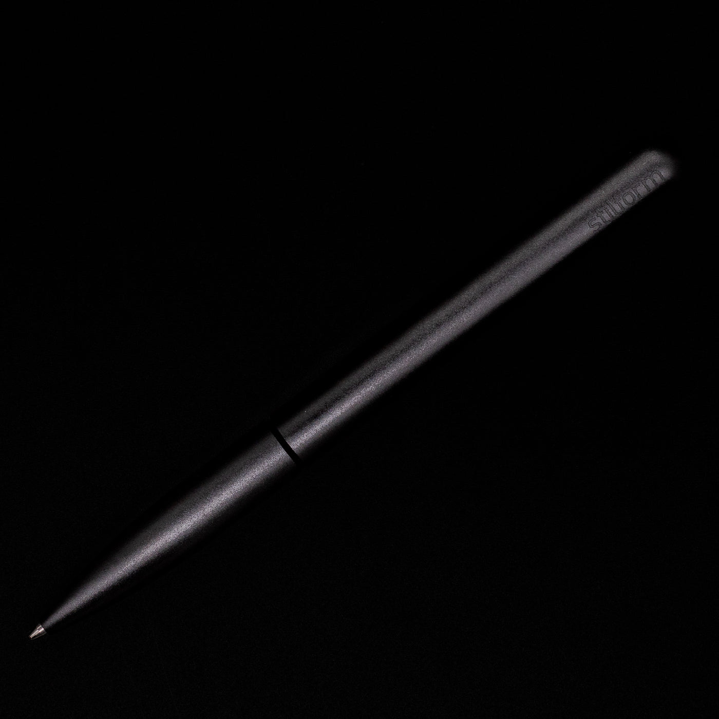 An overhead view of the Stilform PEN Ballpoint Pen – Warp Black Aluminum activated.