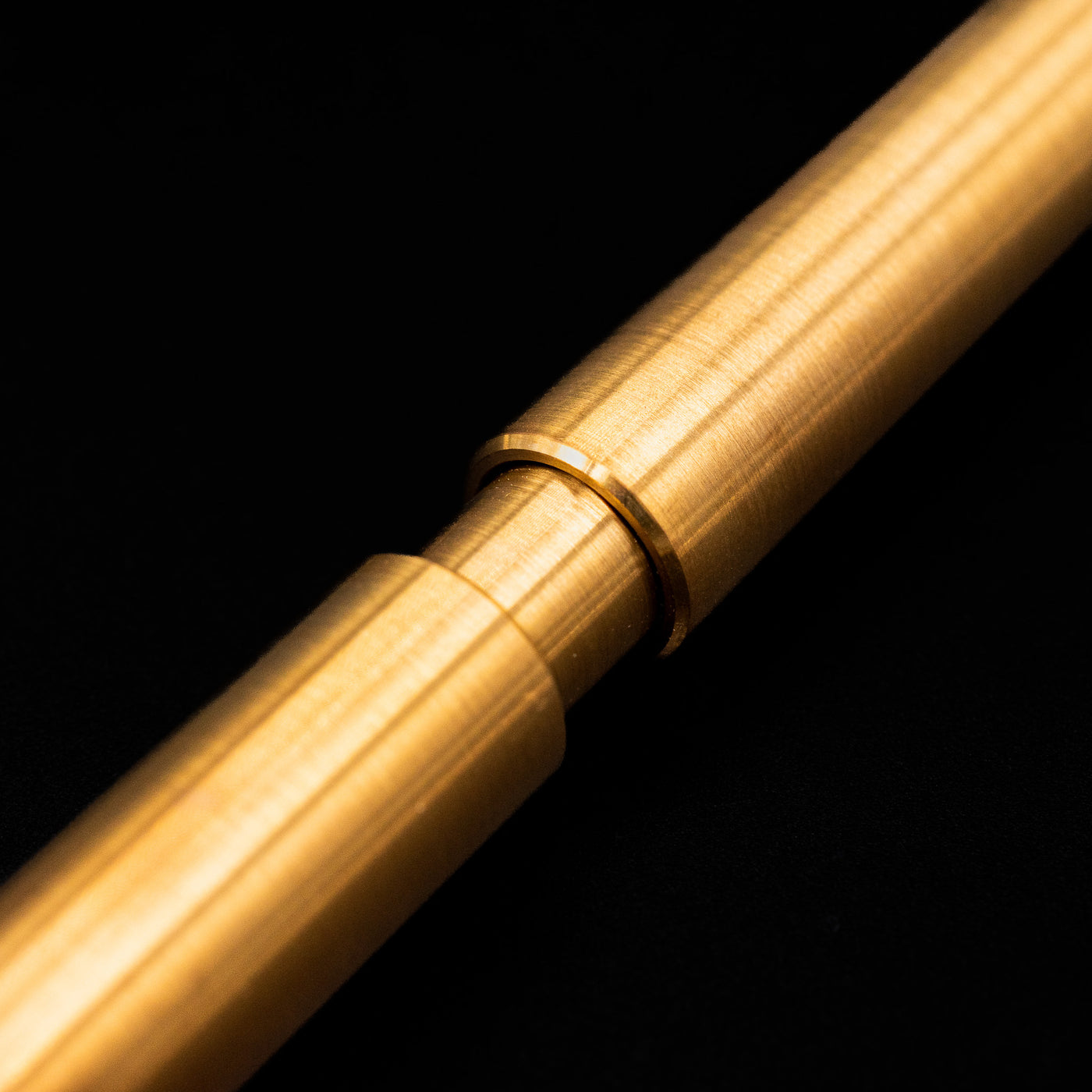A macro shot of the part that activates the Stilform PEN Ballpoint Pen – Brass Radial Brushed.
