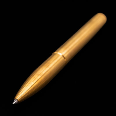 Full view of the Stilform PEN Ballpoint Pen – Brass Radial Brushed angled, showcasing its tip.