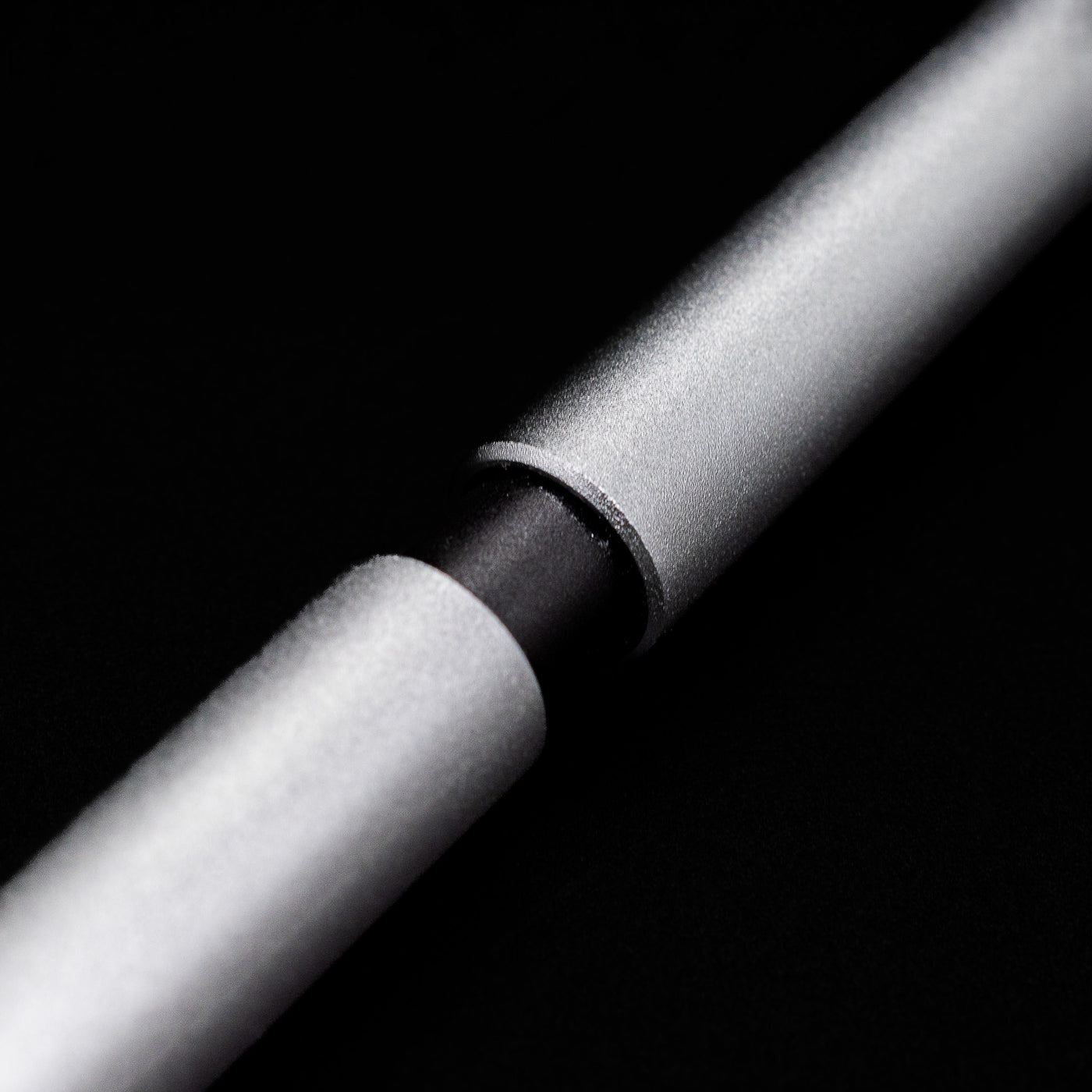 A macro shot of the part that activates the Stilform PEN Ballpoint Pen – Comet Grey Aluminum.
