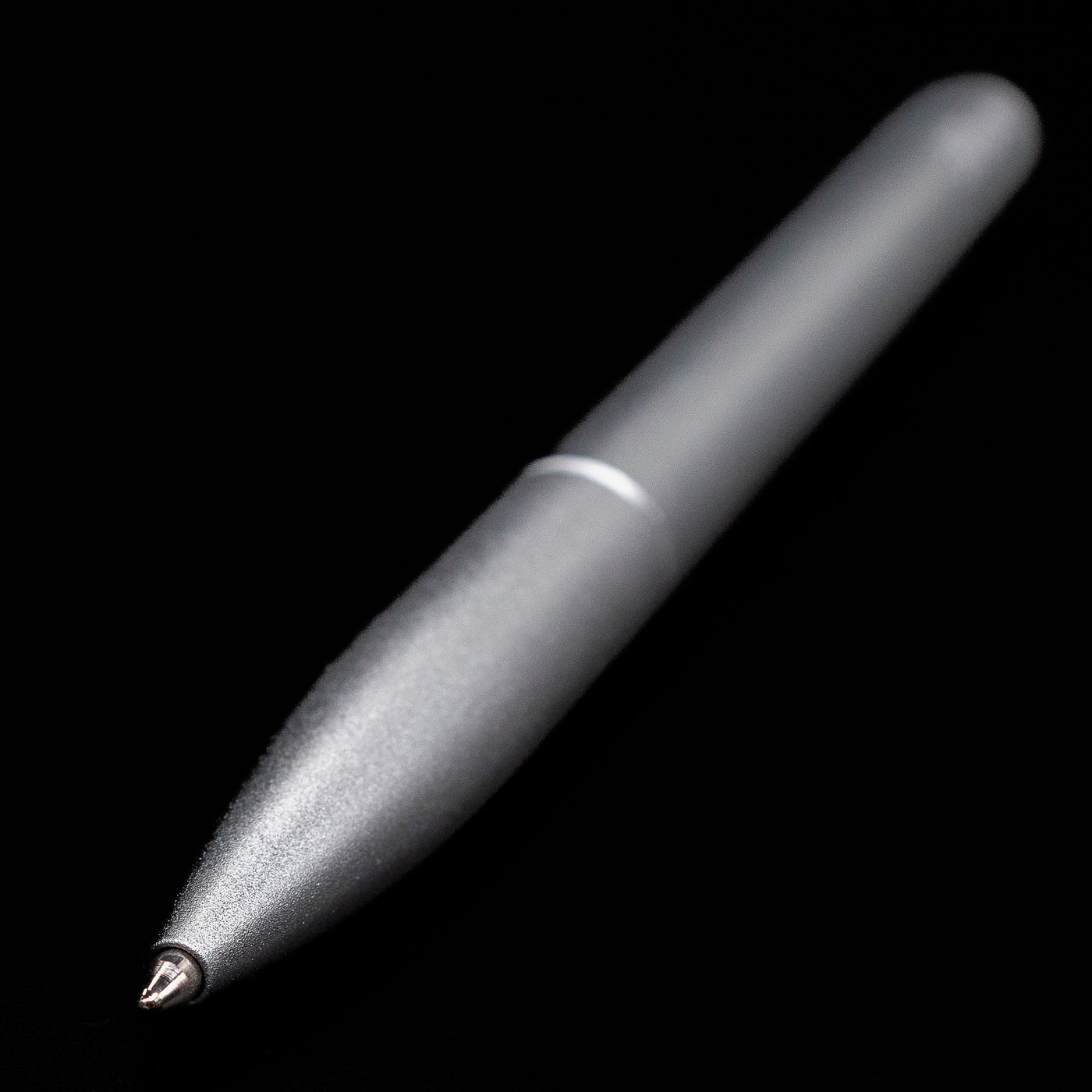 Full view of the Stilform PEN Ballpoint Pen – Comet Grey Aluminum at an angle showcasing its tip.