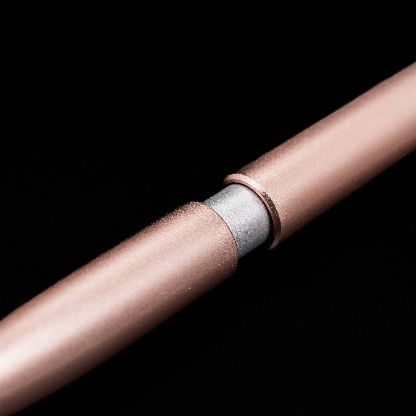 A macro shot of the part that activates the Stilform PEN Ballpoint Pen – Rose Moon Aluminum.
