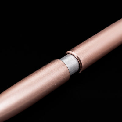 A macro shot of the part that activates the Stilform PEN Ballpoint Pen – Rose Moon Aluminum.
