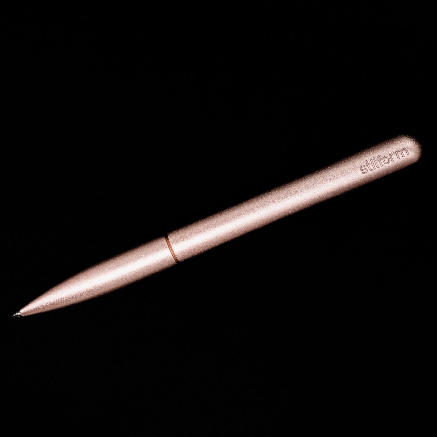 An overhead view of the Stilform PEN Ballpoint Pen – Rose Moon Aluminum activated.