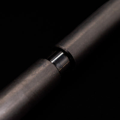 A macro shot of the part that activates the Stilform PEN Ballpoint Pen – Titanium DLC.
