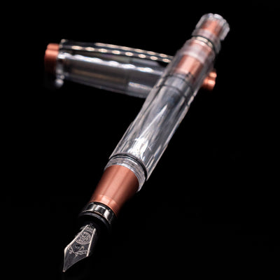 TWSBI Diamond 580ALR Affogato & Onyx Fountain Pen - Preowned laying across its own cap, crossed, with a focus on the nib.