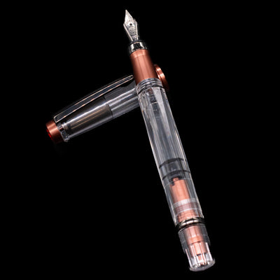 TWSBI Diamond 580ALR Affogato & Onyx Fountain Pen - Preowned laying on top of its cap in a crossed position showing full view of the entire uncapped pen.