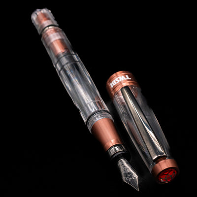 A full view of the TWSBI Diamond 580ALR Affogato & Onyx Fountain Pen - Preowned uncapped, with its cap laying next to the pen. 