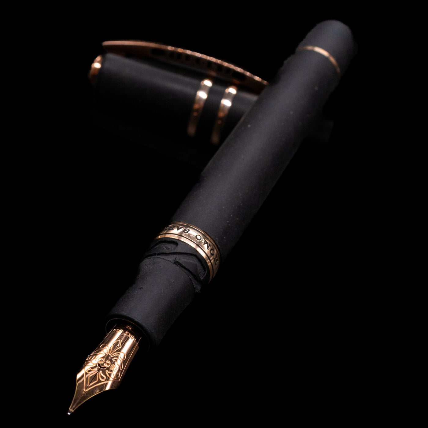 Visconti Homo Sapiens Bronze Age Fountain Pen - Architect Nib laying across its own cap, crossed, with a focus on the nib.