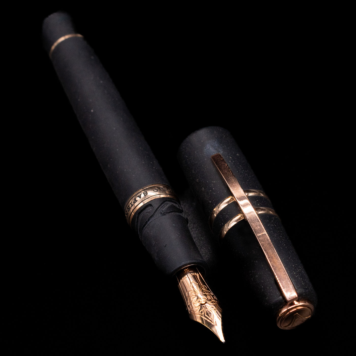 A full view of the Visconti Homo Sapiens Bronze Age Fountain Pen - Architect Nib uncapped, with its cap laying next to the pen. 