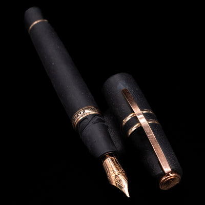 A full view of the Visconti Homo Sapiens Bronze Age Fountain Pen - Architect Nib uncapped, with its cap laying next to the pen. 