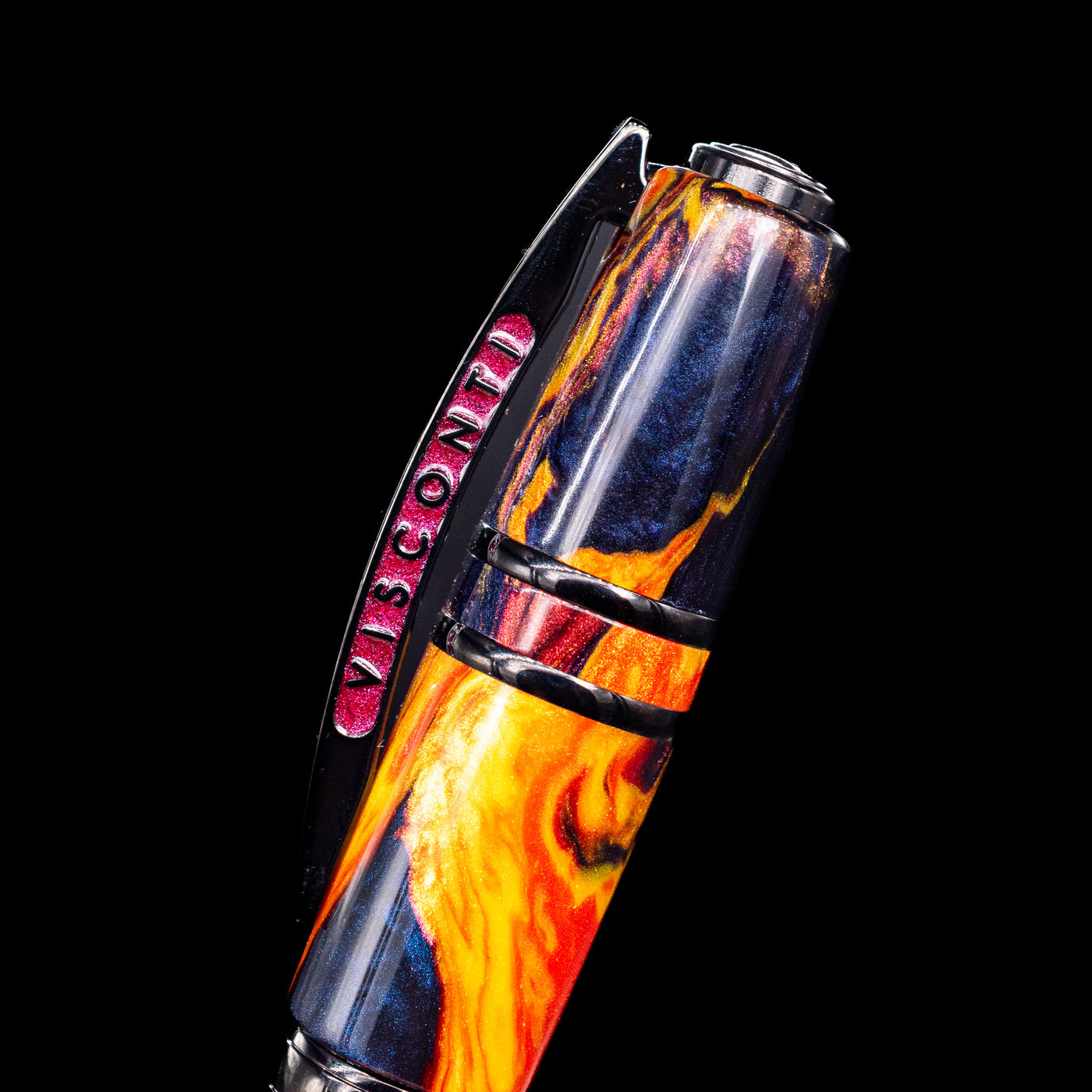 Close-up of the bridge-style clip and marbled cap material, echoing the volcanic Fire theme on the Visconti Homo Sapiens Earth Origins Fire edition fountain pen.