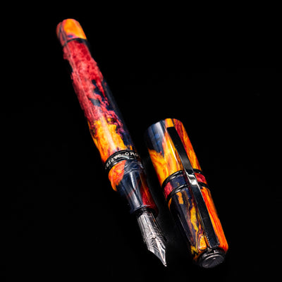 Full view of the uncapped Visconti Homo Sapiens Earth Origins Fire edition fountain pen, barrel and grip section balanced in fiery tones.
