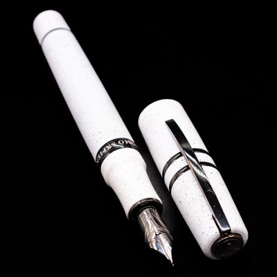 A full view of the Visconti Homo Sapiens Fountain Pen - Blizzard White uncapped, with its cap laying next to the pen. 