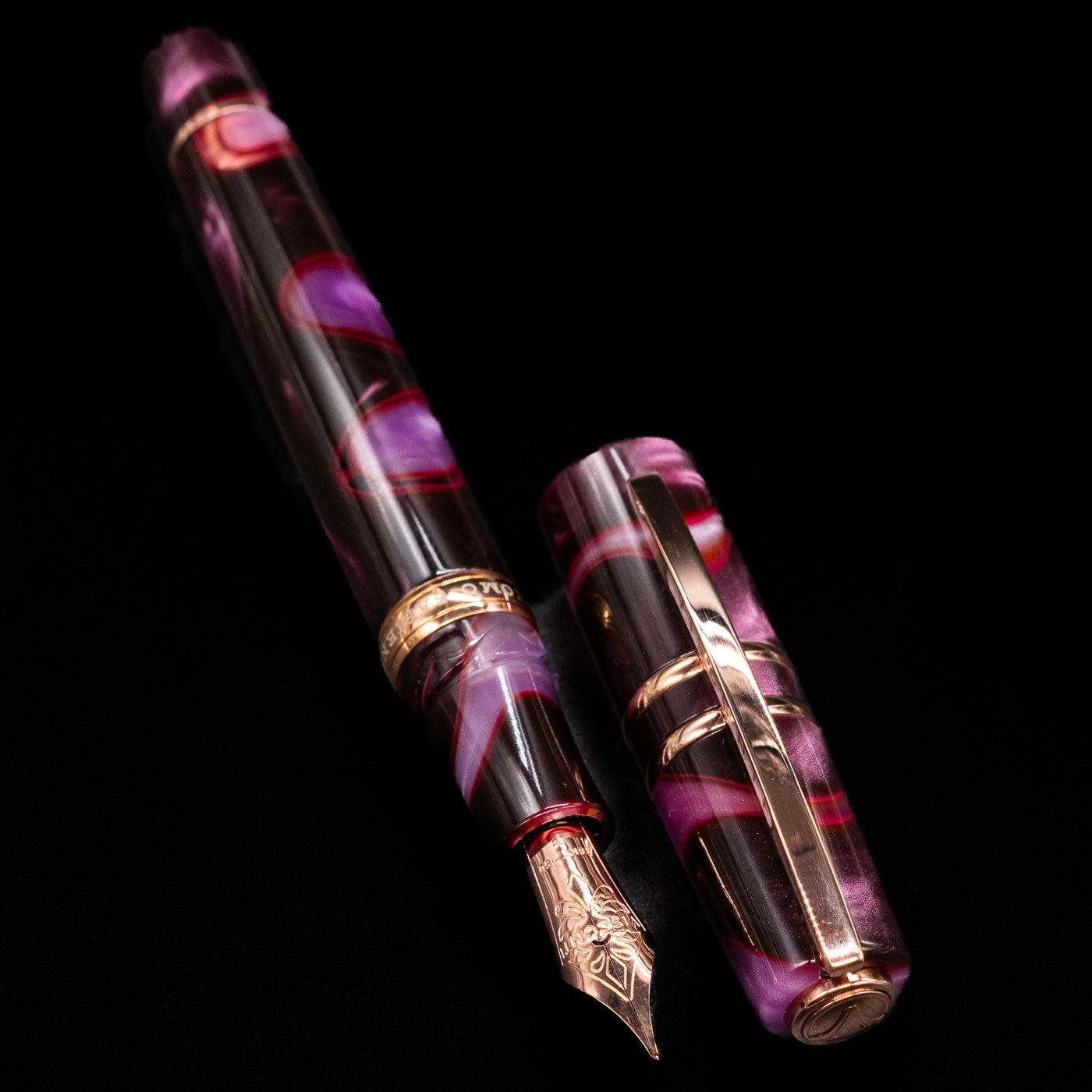  A full view of the Visconti Homo Sapiens Iris Garden Fountain Pen uncapped, with its cap laying next to the pen. 