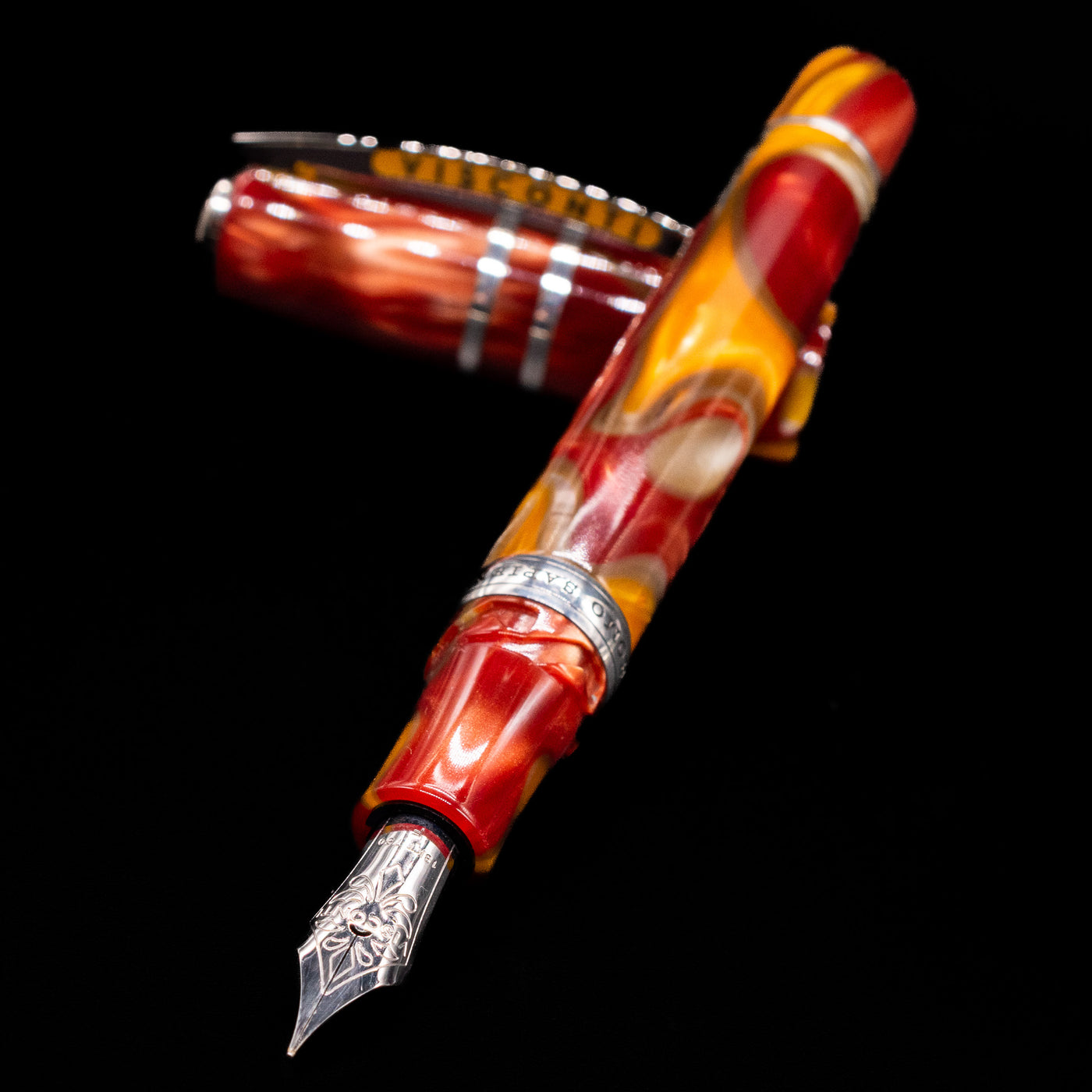 Visconti Homo Sapiens Limited Edition Fountain Pen - Arizona Sunset laying across its own cap, crossed, with a focus on the nib.