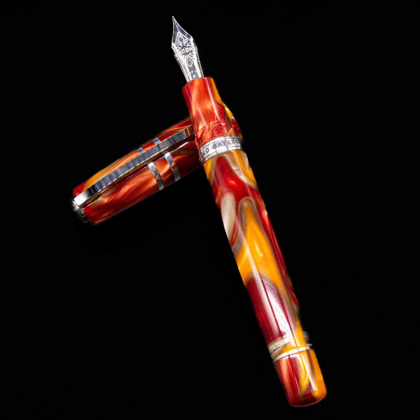 Visconti Homo Sapiens Limited Edition Fountain Pen - Arizona Sunset laying on top of its cap in a crossed position showing full view of the entire uncapped pen.