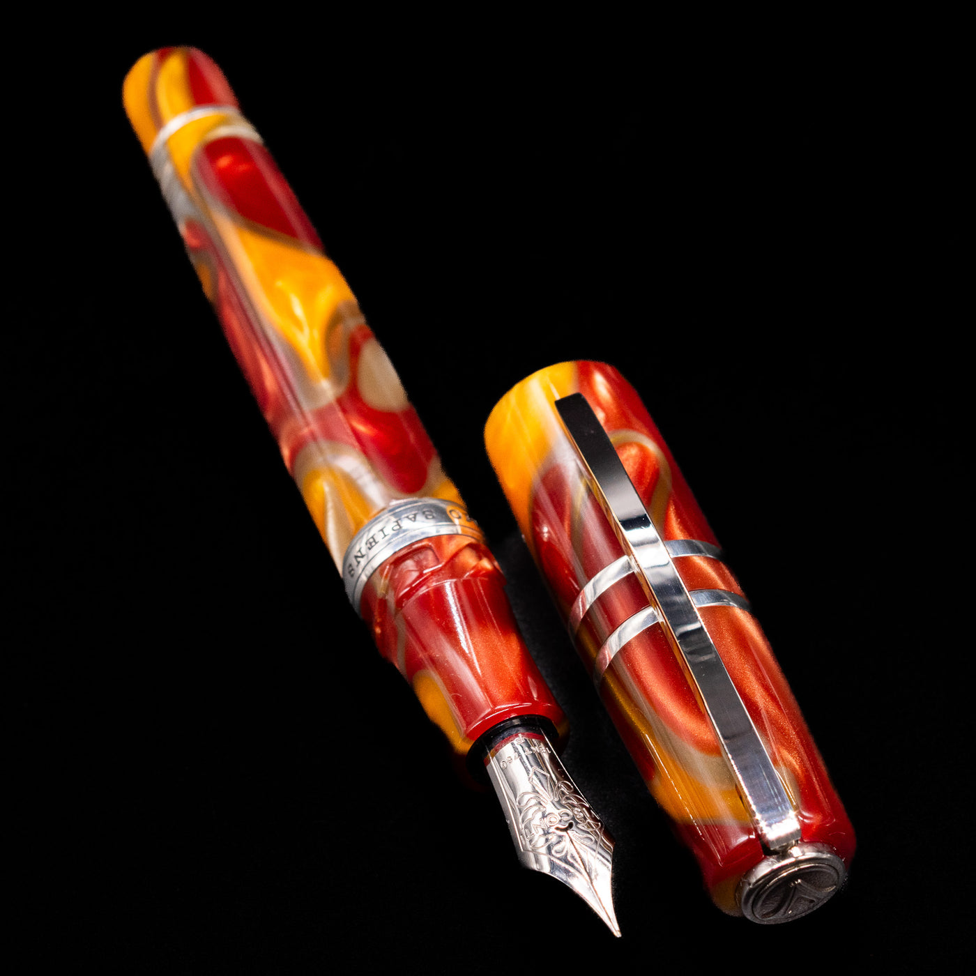 A full view of the Visconti Homo Sapiens Limited Edition Fountain Pen - Arizona Sunset uncapped, with its cap laying next to the pen. 
