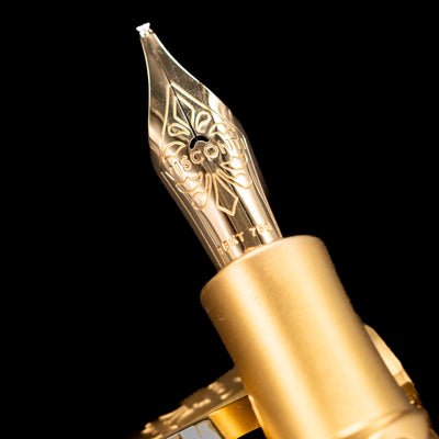 A macro shot of the nib with its intricate detailing and logo engraving for the Visconti Il Magnifico Calacatta Gold Fountain Pen.