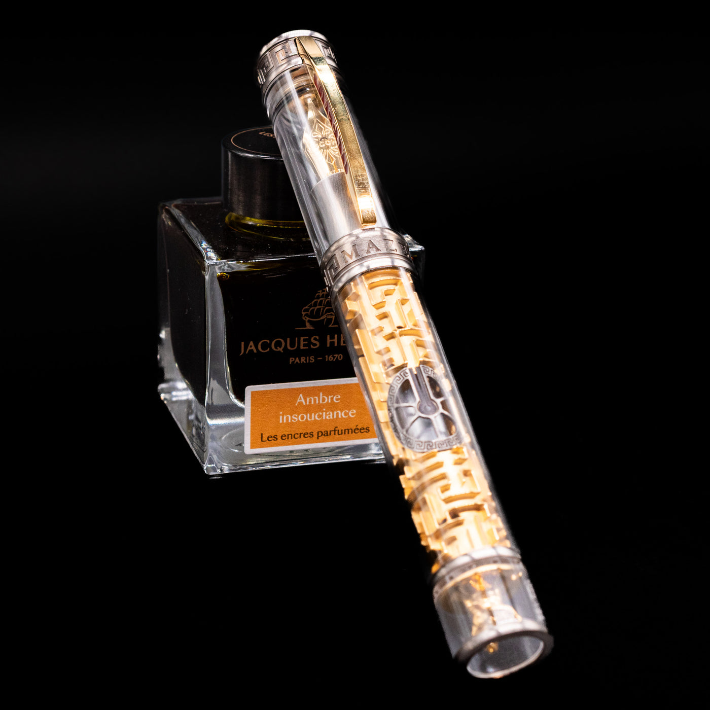 Visconti Limited Edition Fountain Pen - Maze capped, leaning against an ink bottle. 
