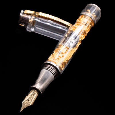 Visconti Limited Edition Fountain Pen - Maze laying across its own cap, crossed, with a focus on the nib.